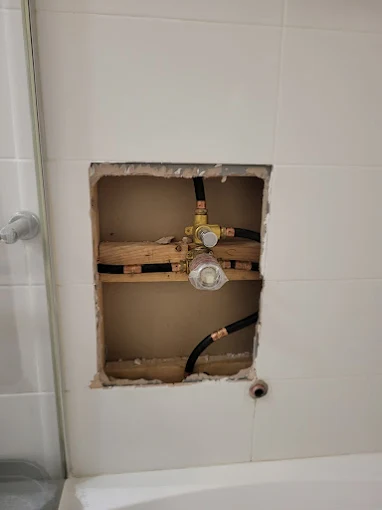 Bathroom pipe rough-in access and repair
