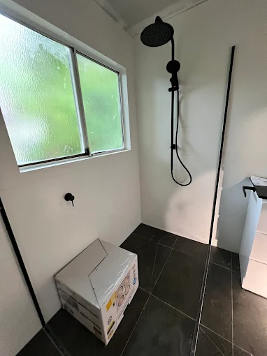 Black fixture rain shower in new bathroom build